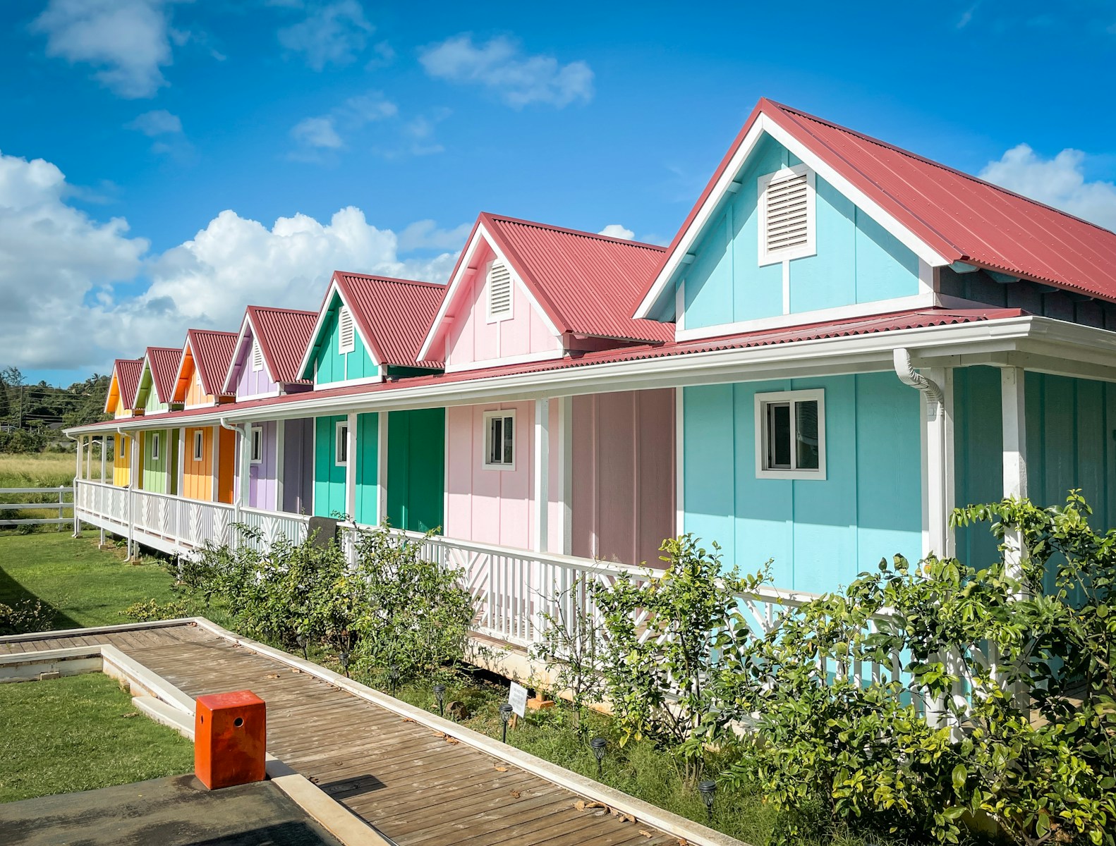 a row of multicolored houses with a wooden deck